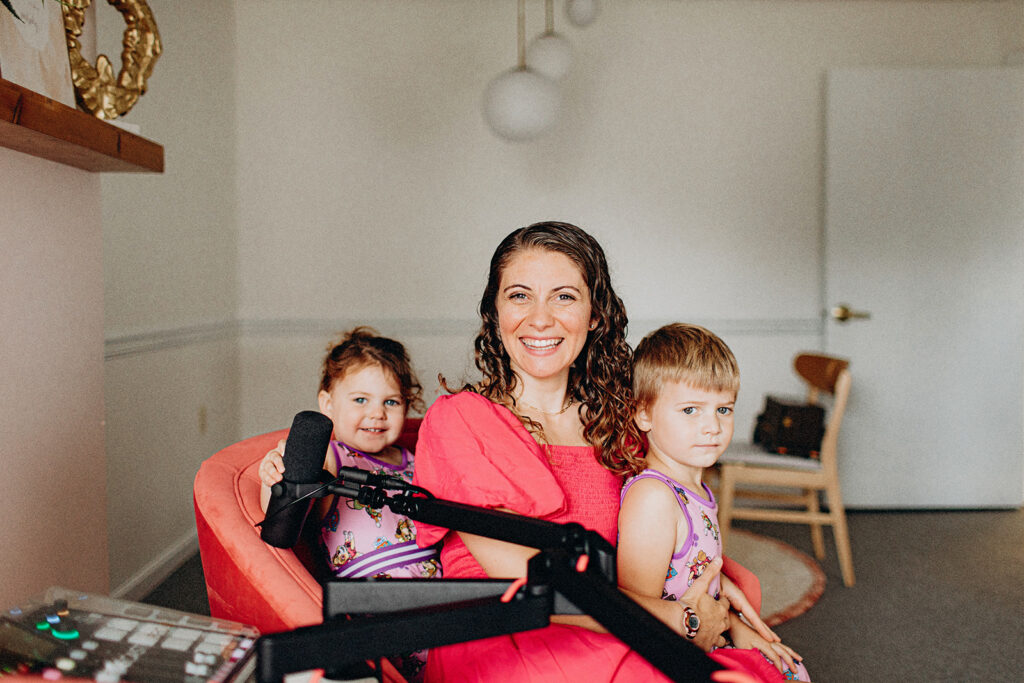 Mompreneur with children behind podcast mic